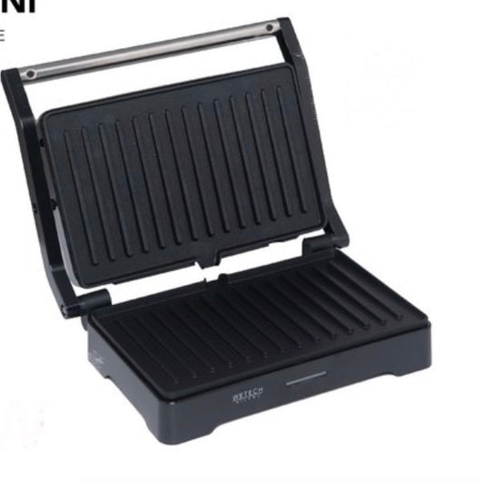Piastra.Ha una finitura a righe su entrambe le piastre e una maniglia argentata. Sembra compatta e adatta per preparare toast, panini o grigliare piccoli alimenti.